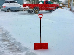 Red shovel in the snow.